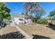 Large backyard with mature trees, a patio area, and a cozy, private outdoor space at 4110 Yates St, Denver, CO 80212