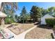 Expansive backyard featuring a shed, mature trees, and plenty of space for outdoor activities at 4110 Yates St, Denver, CO 80212