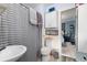 Bright bathroom showcasing stylish fixtures, a practical toilet, and a convenient storage cabinet at 4110 Yates St, Denver, CO 80212