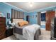 Tranquil bedroom featuring blue walls, plush bed, and ample closet space, perfect for relaxation at 4110 Yates St, Denver, CO 80212