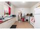 Bright kitchen featuring white cabinetry, tiled backsplash, and access to other rooms at 4110 Yates St, Denver, CO 80212