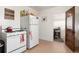 Classic kitchen featuring white cabinetry, a white oven and access to another room at 4110 Yates St, Denver, CO 80212