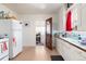 Classic kitchen featuring white cabinetry, durable countertops, and access to other rooms at 4110 Yates St, Denver, CO 80212
