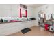 Well-lit kitchen featuring white cabinetry, tiled backsplash, and practical layout at 4110 Yates St, Denver, CO 80212