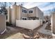Exterior view of a two-story home featuring a well-maintained backyard with a white fence and partial landscaping at 9695 E Kansas Cir # 44, Denver, CO 80247