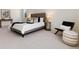 Well-lit primary bedroom with carpet, stylish chair, and plenty of natural light at 9695 E Kansas Cir # 44, Denver, CO 80247