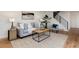 Stylish living room showcasing a modern staircase, comfortable seating, and contemporary decor at 9695 E Kansas Cir # 44, Denver, CO 80247