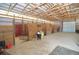 Horse barn interior showing stalls, concrete floor, bright lighting, and convenient access at 2255 Calhoun Byers Rd, Byers, CO 80103