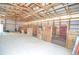 Spacious horse barn featuring multiple stalls and ample natural light through translucent siding at 2255 Calhoun Byers Rd, Byers, CO 80103