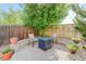 Cozy backyard patio with seating, stone accents, and a shady tree for outdoor enjoyment at 11680 Crow Hill Dr, Parker, CO 80134