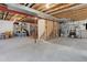 Spacious unfinished basement with exposed beams, shelving, and potential for customization at 11680 Crow Hill Dr, Parker, CO 80134