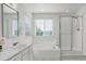 Bright bathroom featuring a tub, glass enclosed shower, large mirror, and double windows at 11680 Crow Hill Dr, Parker, CO 80134