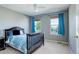 Bedroom featuring a queen bed, grey walls, and natural light from the double windows at 11680 Crow Hill Dr, Parker, CO 80134