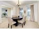 Elegant dining room with a chandelier, neutral walls, and seating for six around a dark table at 11680 Crow Hill Dr, Parker, CO 80134
