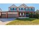 Charming two-story home featuring a welcoming front porch and a spacious three-car garage at 11680 Crow Hill Dr, Parker, CO 80134