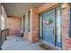 Charming front porch with brick facade, rocking chairs, and a welcoming entrance at 11680 Crow Hill Dr, Parker, CO 80134