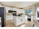 Beautiful kitchen featuring white cabinetry, stainless steel appliances, and light wood floors at 11680 Crow Hill Dr, Parker, CO 80134