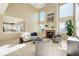 Bright and open living room featuring a fireplace, tall windows, and ample seating at 11680 Crow Hill Dr, Parker, CO 80134