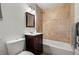 Cozy bathroom with tiled shower and tub featuring dark vanity at 951 S Osage St, Denver, CO 80223
