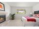 Serene bedroom with a cozy fireplace, large window, and comfortable furnishings at 951 S Osage St, Denver, CO 80223