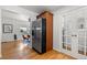 Entryway featuring a stainless refrigerator, hardwood floors, and access to the living area at 951 S Osage St, Denver, CO 80223