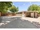 View of the garage and gravel parking area featuring a wooden fence providing privacy at 951 S Osage St, Denver, CO 80223