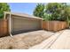 Garage with a large door and fenced area for secure parking and storage at 951 S Osage St, Denver, CO 80223