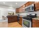 Updated kitchen with stainless steel appliances, granite countertops, and wood cabinetry at 951 S Osage St, Denver, CO 80223