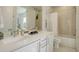 Bright bathroom featuring double sinks, a shower-tub combo, and modern white cabinetry for storage and organization at 3030 Wilson Ct # 5, Denver, CO 80205
