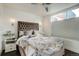 Bedroom features a tufted headboard, stylish lighting, and a large window offering natural light and outdoor views at 3030 Wilson Ct # 5, Denver, CO 80205