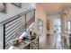 Hallway features wood floors, a staircase with metal railings, and a view into a stylishly appointed bathroom at 3030 Wilson Ct # 5, Denver, CO 80205