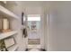 Hallway showing decor, shelves, and a bathroom featuring double sinks, a mirror, and modern lighting at 3030 Wilson Ct # 5, Denver, CO 80205