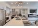 Modern kitchen featuring stainless steel appliances, sleek white cabinetry, and a stylish lighting fixture at 3030 Wilson Ct # 5, Denver, CO 80205