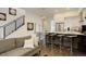 Open-concept living area showcasing stairs, a modern kitchen, and hardwood floors at 3030 Wilson Ct # 5, Denver, CO 80205