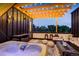 Inviting rooftop deck featuring a hot tub, comfortable seating, and string lights for a relaxing outdoor experience at 3030 Wilson Ct # 5, Denver, CO 80205