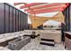 Relaxing rooftop deck with hot tub, lounge seating, and stylish sun shade at 3030 Wilson Ct # 5, Denver, CO 80205