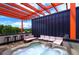 Inviting rooftop deck with a hot tub, comfortable seating, and a vibrant orange pergola at 3030 Wilson Ct # 5, Denver, CO 80205