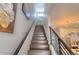 Elegant staircase showcasing wood steps, dark metal railings, and a view of the home's modern lighting fixtures at 3030 Wilson Ct # 5, Denver, CO 80205