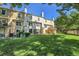 Large, shady backyard featuring green grass, townhomes, and small patio at 9320 W Ontario Dr, Littleton, CO 80128