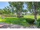 Large, grassy backyard featuring mature trees and a wooden fence at 9320 W Ontario Dr, Littleton, CO 80128