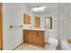 Bathroom featuring a dual-sink vanity, toilet, and shower at 9320 W Ontario Dr, Littleton, CO 80128