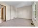 A naturally lit bedroom with neutral paint and carpet at 9320 W Ontario Dr, Littleton, CO 80128