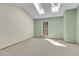Bright bedroom featuring two skylights, a window, and neutral paint tones at 9320 W Ontario Dr, Littleton, CO 80128