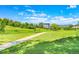 View of the community with a walking path, grassy areas, and nearby homes at 9320 W Ontario Dr, Littleton, CO 80128