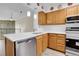 Well-lit kitchen boasts white countertops and stainless steel appliances at 9320 W Ontario Dr, Littleton, CO 80128