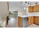 Modern kitchen features a stainless steel dishwasher and light wood cabinets at 9320 W Ontario Dr, Littleton, CO 80128