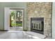 Living room featuring a stone fireplace and sliding glass doors to the outdoor patio at 9320 W Ontario Dr, Littleton, CO 80128