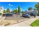 View of a large parking lot area available for residents, surrounded by mature trees and landscaping at 9320 W Ontario Dr, Littleton, CO 80128