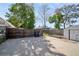 Backyard featuring a shed, concrete patio area, bordered by a wooden fence, and mature trees providing shade at 3817 Osage St, Denver, CO 80211