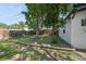 Spacious backyard with a lush lawn, bordered by a wooden fence, and stone pathways to the side of the home at 3817 Osage St, Denver, CO 80211